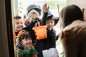 Little children trick or treating on Halloween children's world