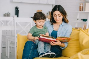 Mom Reading Book to Toddler | Children's World Learning Center